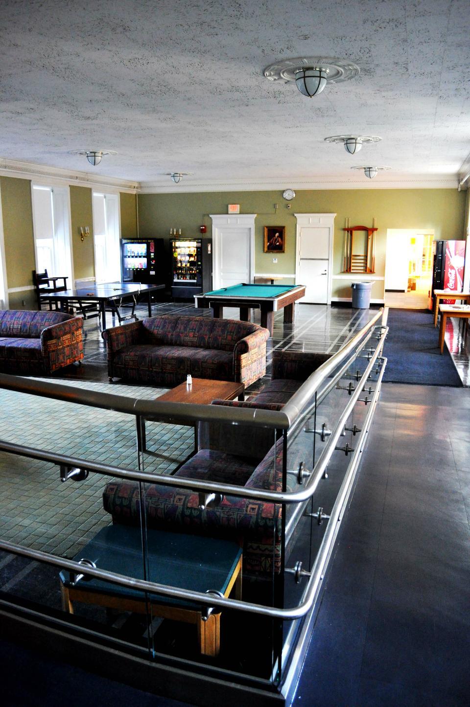 The Pforzheimer Holmes Junior Common Room currently features several couches, a TV, a ping pong table, and a foosball table, and is adjacent to the Quad Grill.