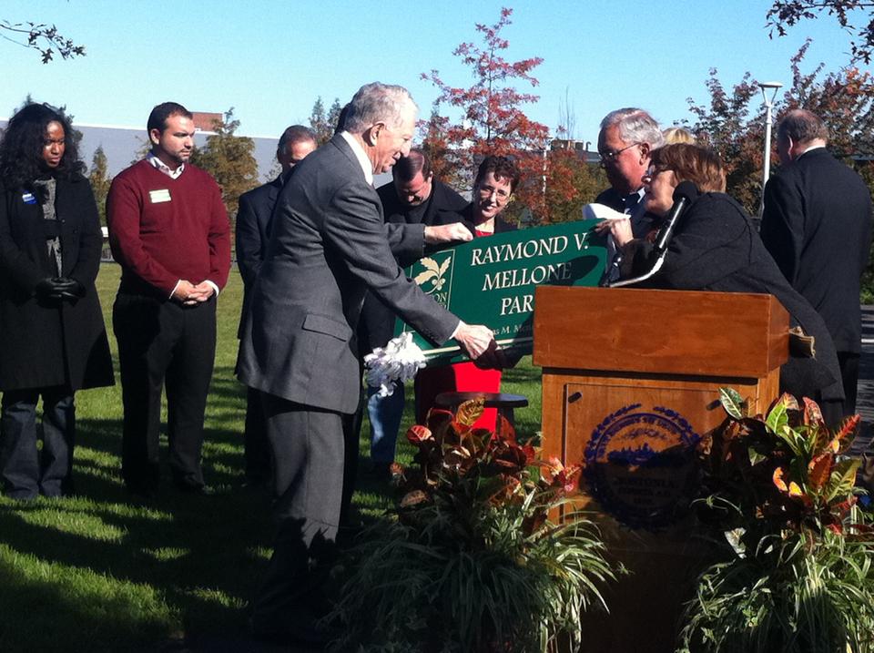 Boston Mayor Thomas M. Menino presents a sign to long-time Allston resident Raymond V. Mellone Saturday morning as the announcement was made that Library Park would be named after Mellone.  