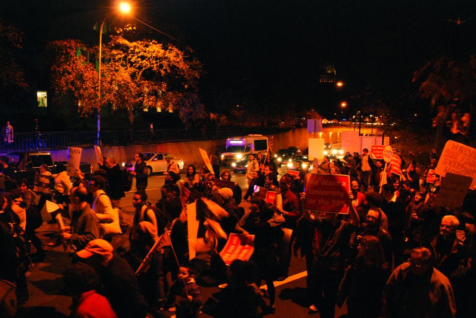 Protesters block traffic on Cambridge Street as they march to Harvard Law School on Wednesday night.