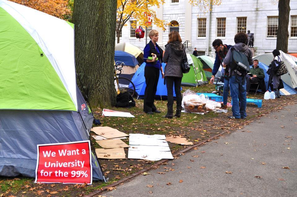 Hannah Hofheinz, a ThD candidate at the Harvard Divinity School, explains the movement to a curious woman as two members of the Occupy Harvard movement grab breakfast.