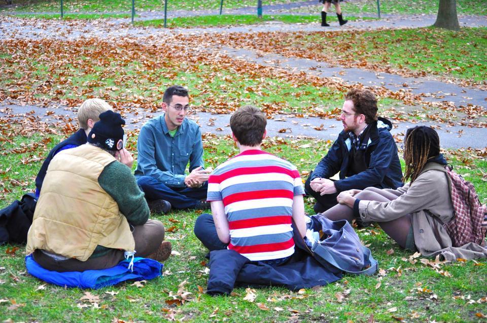 Members of the Occupy Harvard movement's facilitation working group convene in Harvard Yard with a request that journalists not distract or interrupt the group's meeting.