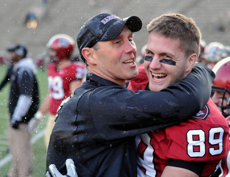 Harvard senior Chris Lorditch embraces head coach Tim Murphy shortly after soaking him with Powerade. Harvard defeated Penn 37-20 and claimed its 14th Ivy League Championship on Nov. 12. 