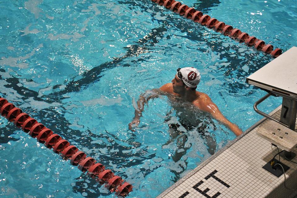 Griffin Schumacher, freshman, waits for his time to appear after the 200 yard medley relay, which Harvard's team 'A' won in the meet against Cornell and Dartmouth on Saturday.