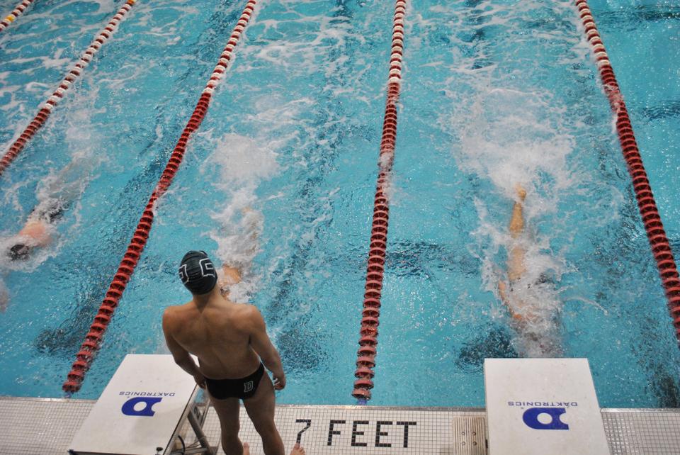 The swimmers of Harvard, Cornell, and Dartmouth ready themselves for the 200 yard medley, which Harvard won along with the rest of the meet on Saturday.