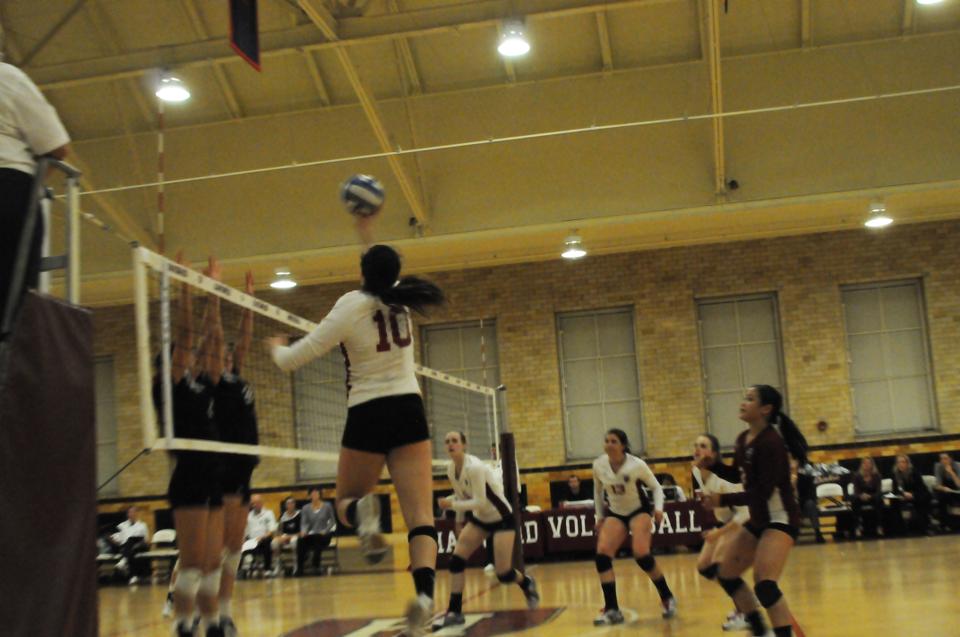 Freshman, Kristen Casey, spikes the ball as Harvard takes the lead. 