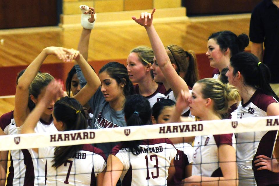 The volleyball team gathers together at the end of a game against Yale on Friday.  