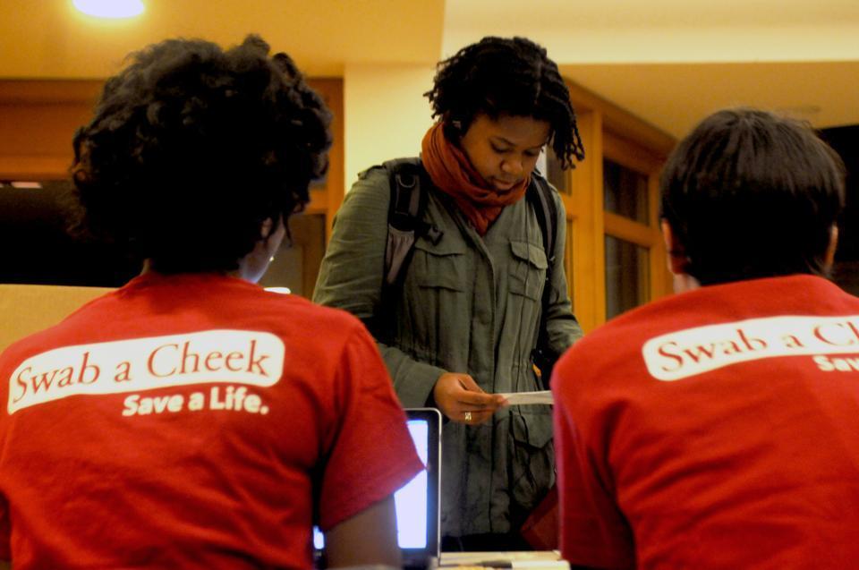 Candice Porter '13 checks in with Jasmine Omeke '12 and Jason Wien '13 to see if she is an eligible bone marrow donor Wednesday afternoon at Harvard Hillel.