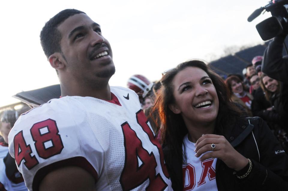 Josue Ortiz and Kayci Baldwin '14 celebrate their recent engagement at the end of The Game.