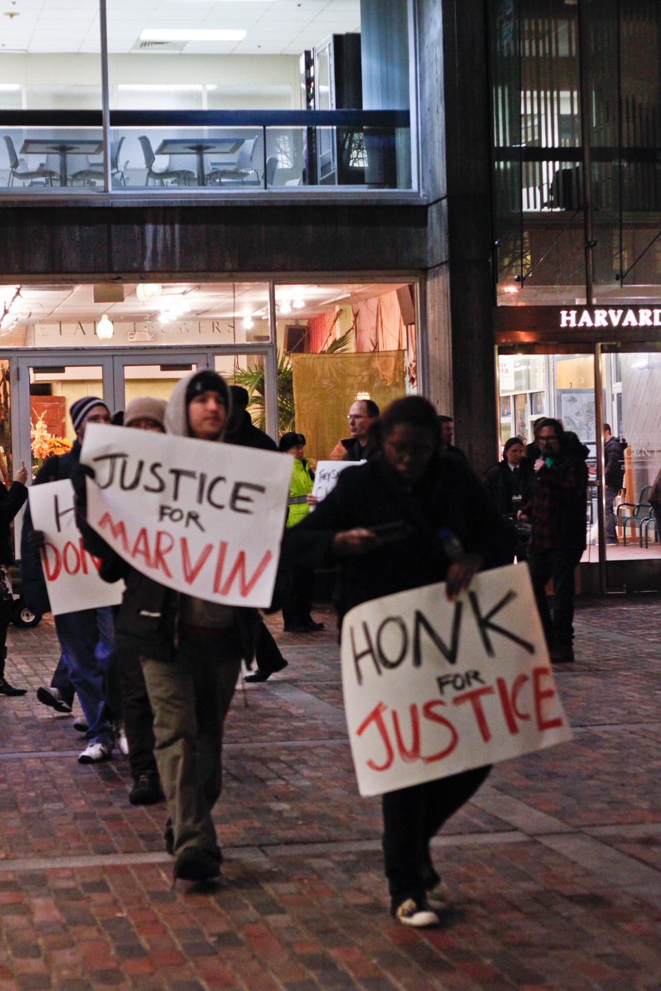 Union members and Harvard students show their support for Marvin Byrd and their discontent with Harvard University Mail Services' treatment of Byrd outside the Holyoke Center on Thursday evening. Byrd, an African-American mail room employee since 1995, supposedly was the only staff member to have his hours cut.