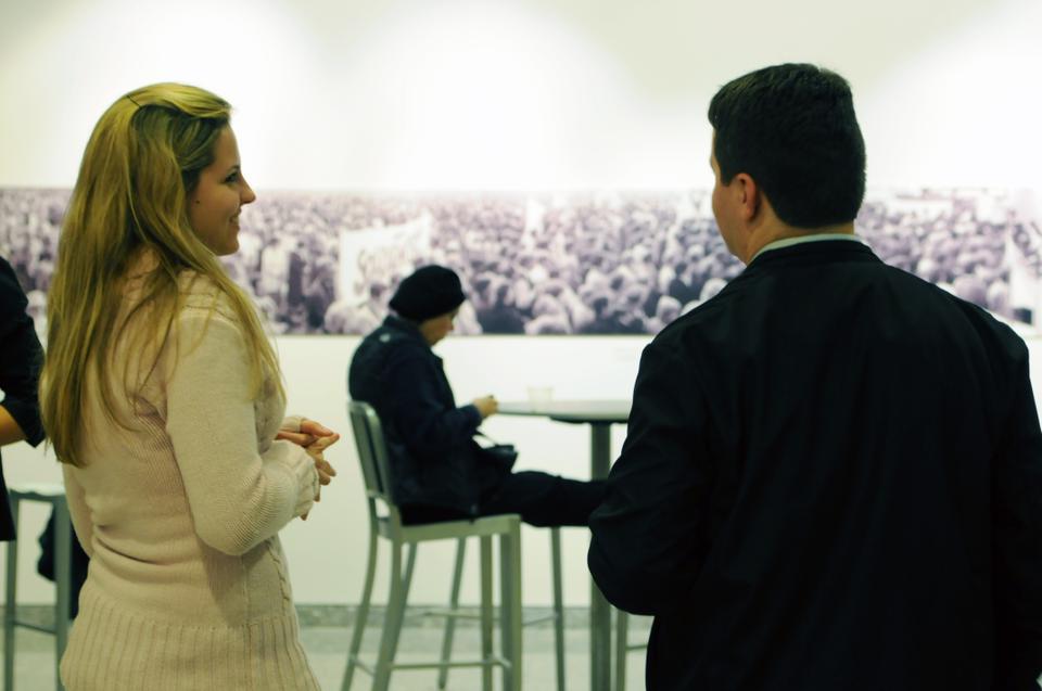 Patrons peruse the photographs at the opening of the CGIS exhibition entitled “Poland, Solidarity, and Martial Law, 1980-1981:  A 30-Year Retrospective”. The exhibition will run on the CGIS South Concourse until Jan. 17, 2012.
