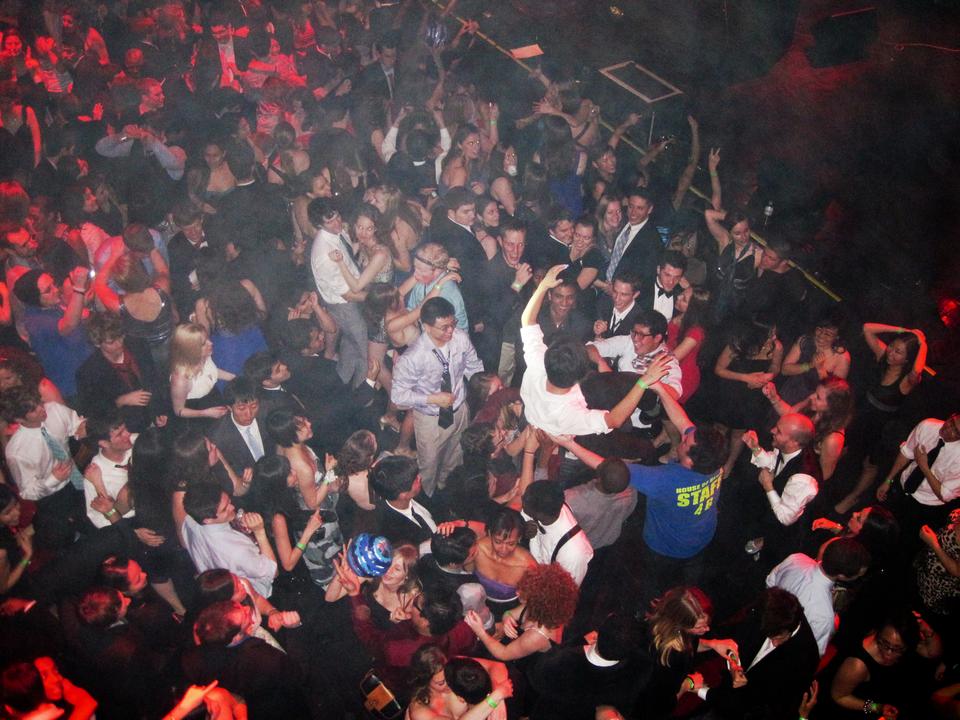 A House of Blues staff member intervenes in a student's risky crowd surfing venture at the 5 House Formal on Sunday.