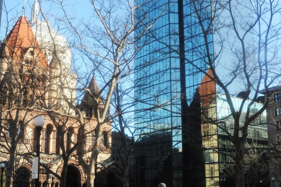Trinity Church, one of the most famous churches in Boston, reflects against the John Hancock on a bright January day. 