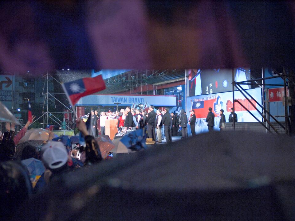 Taiwan presidential incumbent Ma Ying-jeou of the KMT party won reelection on January 15th, 2012.  This photo was taken outside of the KMT headquarters in Taipei in the rain while he gave his victory speech.