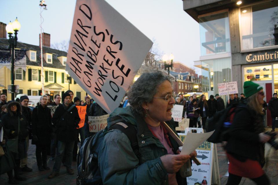 Protestors join together in a rendition of “Solidarity Forever” in front of the Holyoke Center Thursday evening before marching through Harvard Yard in opposition to proposed reductions in numbers of Harvard’s library workers.