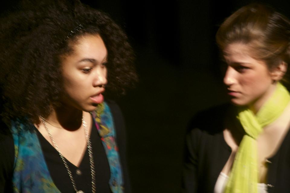 Christina Twicken and Maddie Coveno perform a duet monologue titled "My Vagina Was My Village". The monologue was based on one Bosnian woman refugee's experience of being raped as a systematic tactic of view.