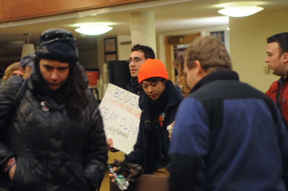 Occupy Harvard protesters collect their belongings before leaving Lamont Friday night. The sign reads, "Greetings to the Bogazici Starbucks Counter
Occupation, Occupy Harvard," an occupation in Istanbul, Turkey that is similar to Occupy Harvard.