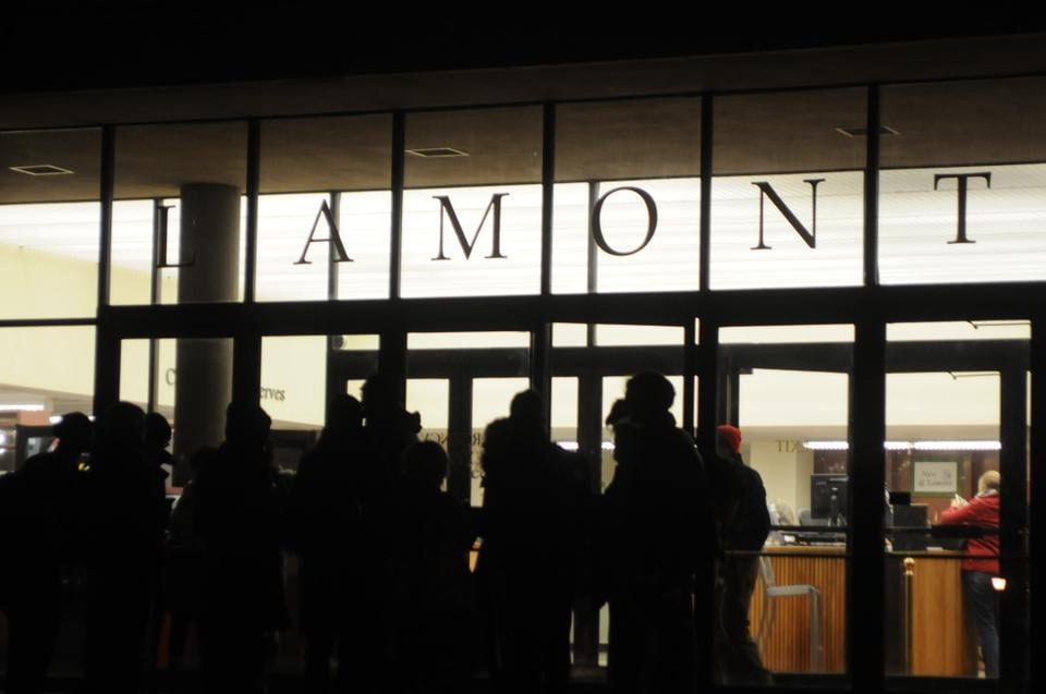 Occupy Harvard protesters gather for a last cheer on the steps of Lamont before leaving Friday night. Because the library closes at 10pm on Fridays, the protesters could not stay in Lamont Cafe.