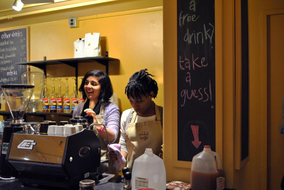 Baristas Akanksha Sharma ‘14 and Marie-Fatima Hyacinthe ‘14 greet customers in Cabot Cafe, where it offered new drinks and pastries, more seating, lower prices, and new artwork as decor after its grand reopening. 