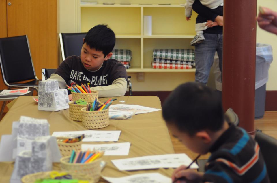 Wiley Wu, age 10, and Kevin Wang, age 7, color replicas of Mexican monuments at the Mexican Flag Day Family Event held at the Peabody Museum on Tuesday.