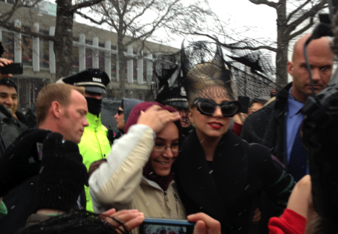 Lady Gaga posing with a fan.