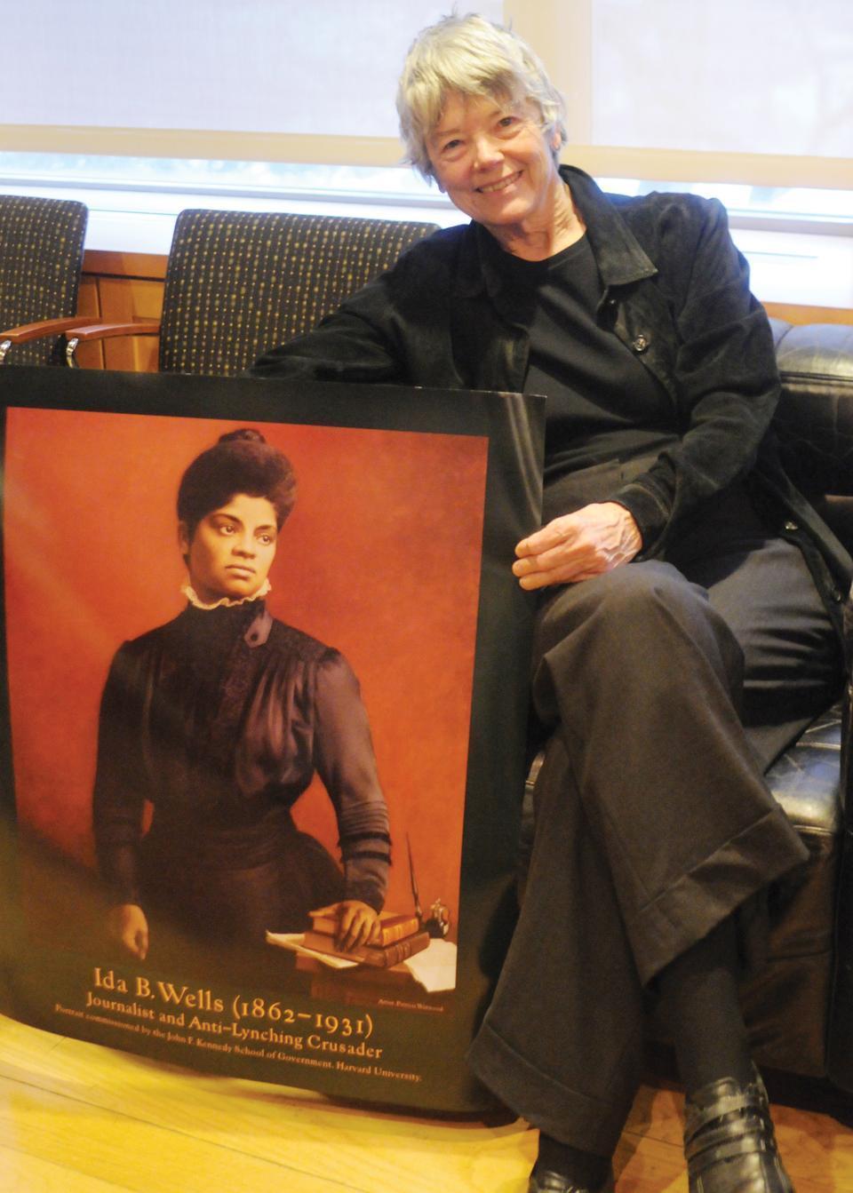 Harvard Kennedy School Professor Jane Mansbridge, pictured here with a poster of Ida B. Wells, speaks on how women in history measure just as profoundly as men do.