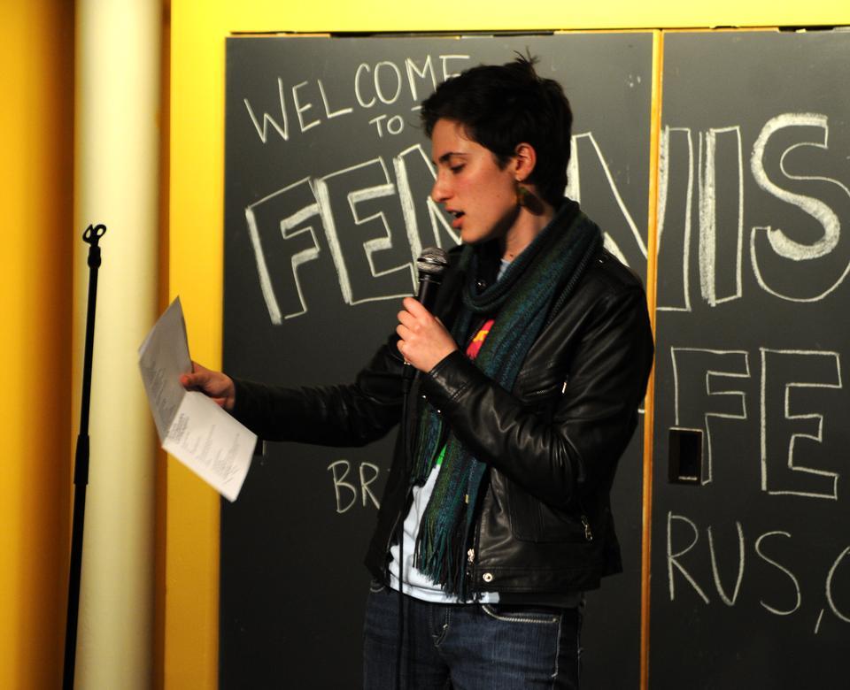 Cassandra Euphrat Weston ‘14 reads an original poem about the importance of feminism during Feminist Coming Out Day on Thursday. Feminist Coming Out Day was founded by Harvard alum Lena Chen ‘10.
