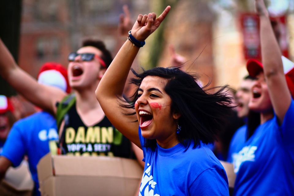 Akanksha Sharma ‘14 celebrates with other residents of Cabot House in Harvard Yard. On Thursday morning residents of each House met and converged on the Yard where they visited each freshman dorm to welcome members of the Class of 2015 into their upperclassmen houses.