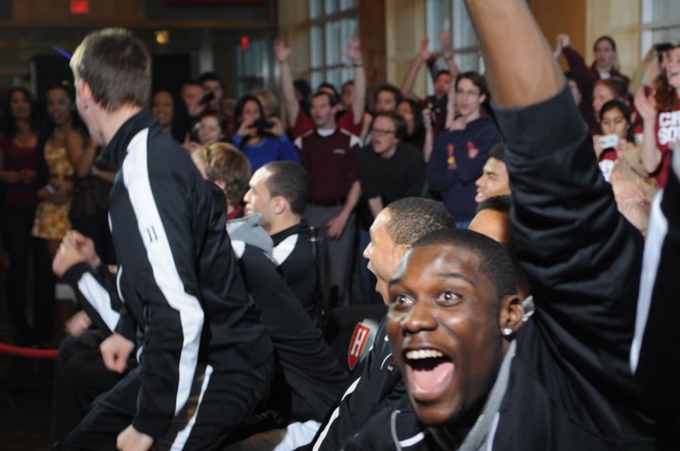 The Harvard men's basketball celebrates after the announcement of its NCAA tournament seeding at the Murr Center Sunday evening.