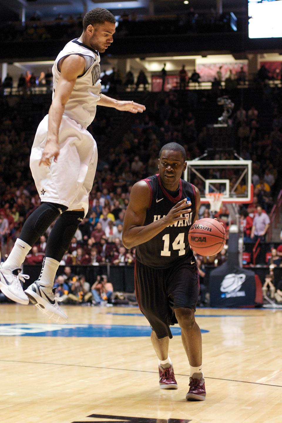 Freshman Steve Moundou-Missi tries to dribble past a leaping Jeffery Taylor in the Harvard men's basketball team's 79-70 loss on Thursday to Vanderbilt in the second round of the NCAA tournament.