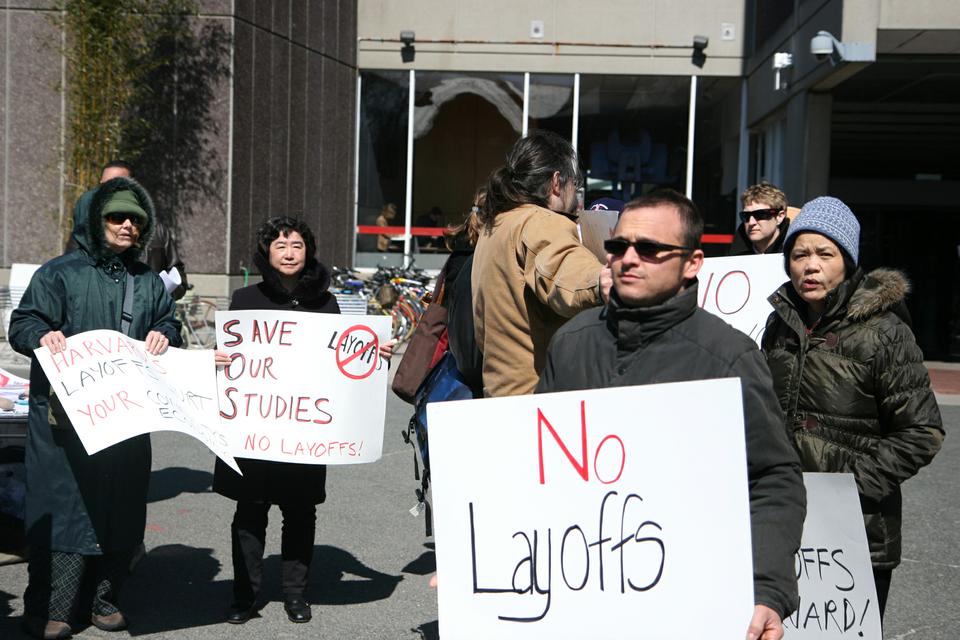 Students, faculty, and library staff protested proposed library cuts in front of the Science Center, emphasizing that the cuts could make it take longer to process research requests and pose challenges to scholars at Harvard.