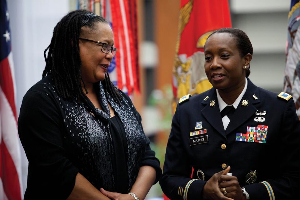Army Col. Twala D. Mathis (right), commander of the 2nd ROTC Brigade, joins Dean of the College Evelynn M. Hammonds at the ribbon-cutting ceremony for Harvard's new Army ROTC office.