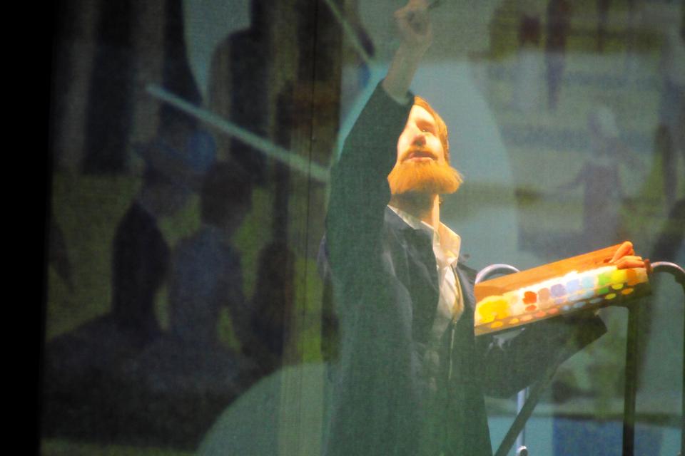 Freshman Mark Mauriello, playing the role of Georges Seurat, is seen through his canvas during the first act of Sunday in the Park with George, which premiered this weekend in the Loeb Mainstage.