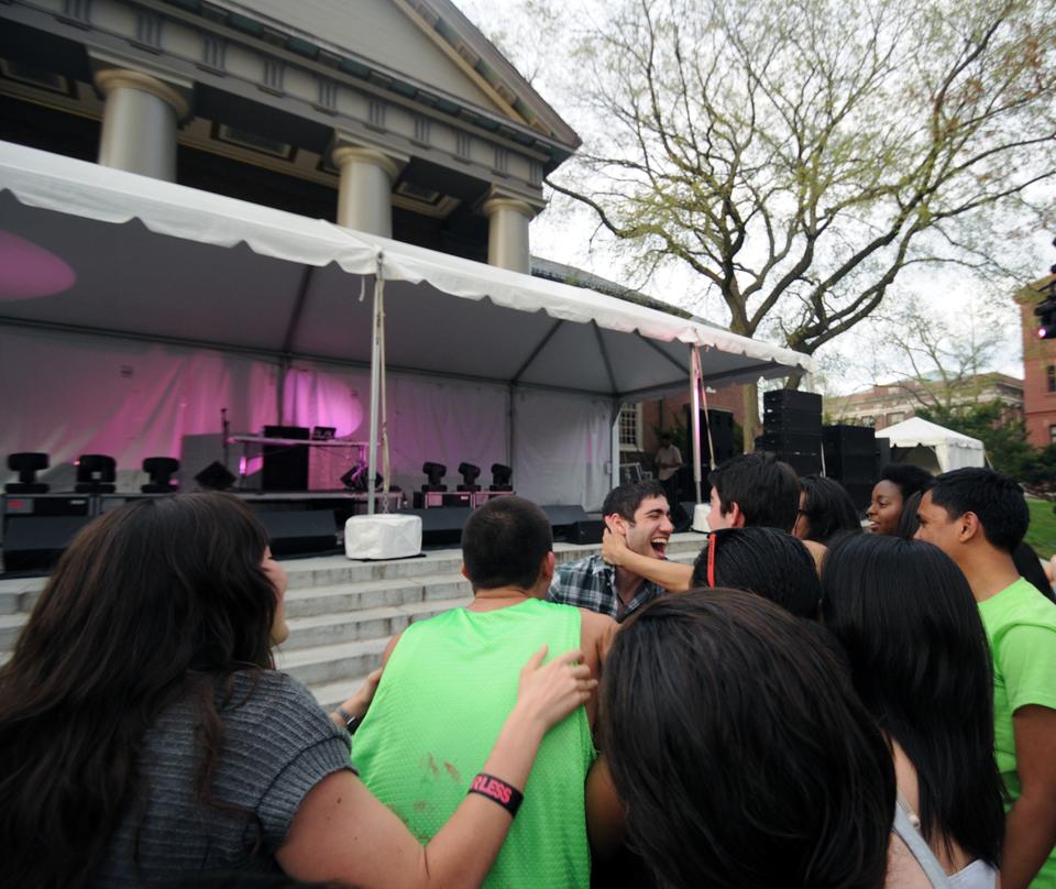 Performer 3LAU spontaneously jumps offstage to embrace his adoring fans for a few moments before resuming his performance. 