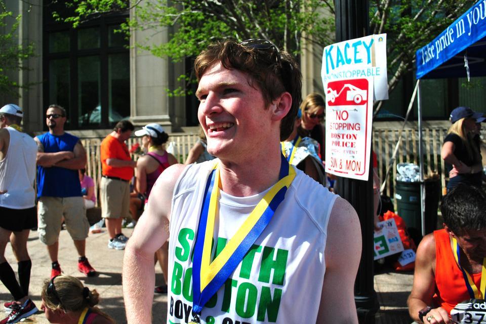 Will L. Fletcher '12 chats with his supporters and friends after finishing the Boston Marathon early Monday afternoon, which he ran to support the South Boston Boys and Girls Club.