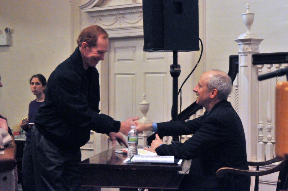 Professor Michael Sandel of the Government Department signs copies of his new book, "What Money Can't Buy- The Moral Limits of Markets," after a discussion of its content on Monday evening in Harvard Square.