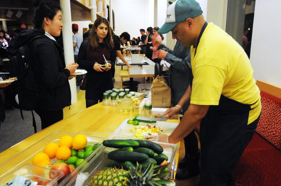 Clover passes out freshly made fruit salads at Taste of Harvard Square in Bolyston Hall. The event drew a long line out of the door while students waited to try delectable tidbits from multiple restaurants in the Square.