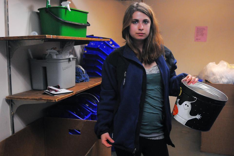 Nicole J. Levin ’15 models a sweatshirt and Halloween tin.  