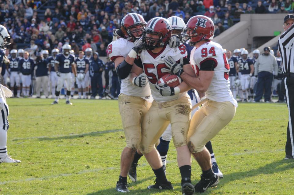 Sophomore defensive tackle Jack Dittmer celebrates after intercepting a Patrick Witt pass in the Harvard 
football team’s annual contest against Yale. The Crimson routed the Bulldogs 45-7 in the 128th playing of The Game.