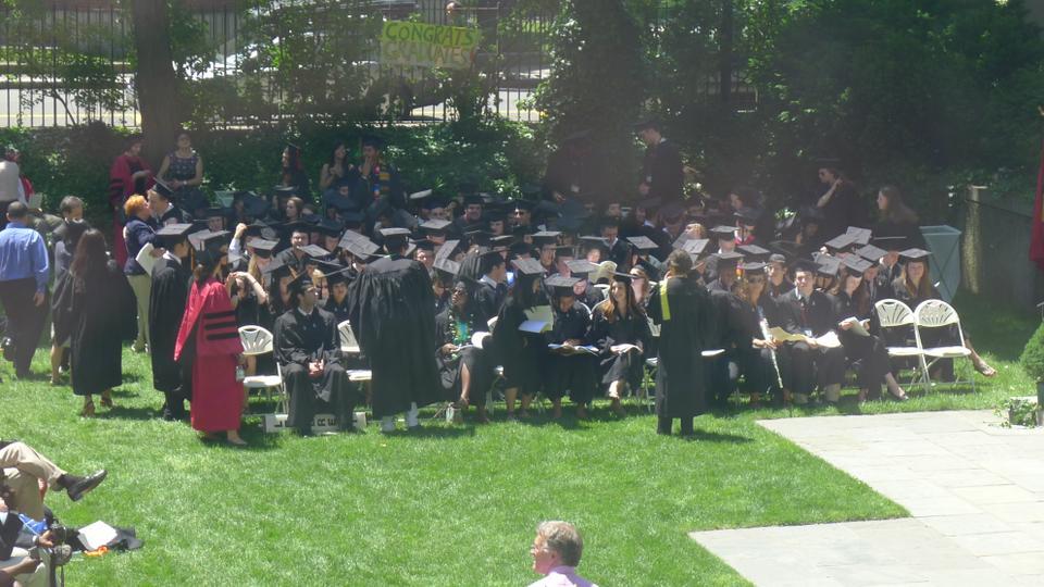 Students assemble in the courtyard at Leverett House to receive their degrees.