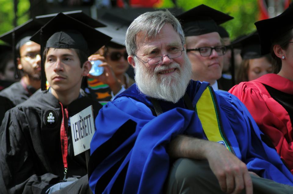 Leverett House Master and physics professor Howard M. Georgi '68 sits in his House Master's robe at Commencement. According to tradition, House Masters join their graduating seniors in Commencement exercises, wearing their house colors.