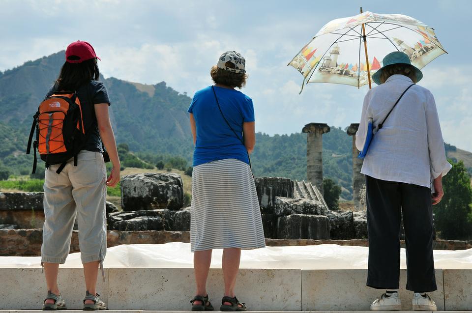 Tourists, standing in the Temple of Artemis, look up at the Sardis Acropolis.