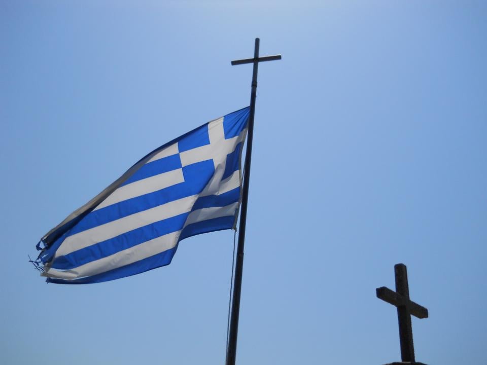 A Greek flag at the top of a castle in Nafpaktos. 
