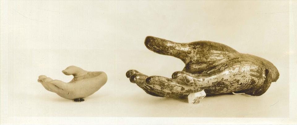 A fragment from a 12th–14th century Thai bodhisattva statue, along with the plasticene copy made by a pupil at the Perkins Institute who manually explored and copied the hand.