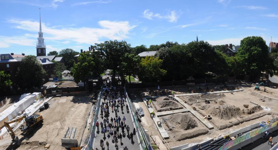 Pedestrians walk through a busy, bottle-necked path on Tuesday as construction on the adjacent areas of the Science Center plaza continues.