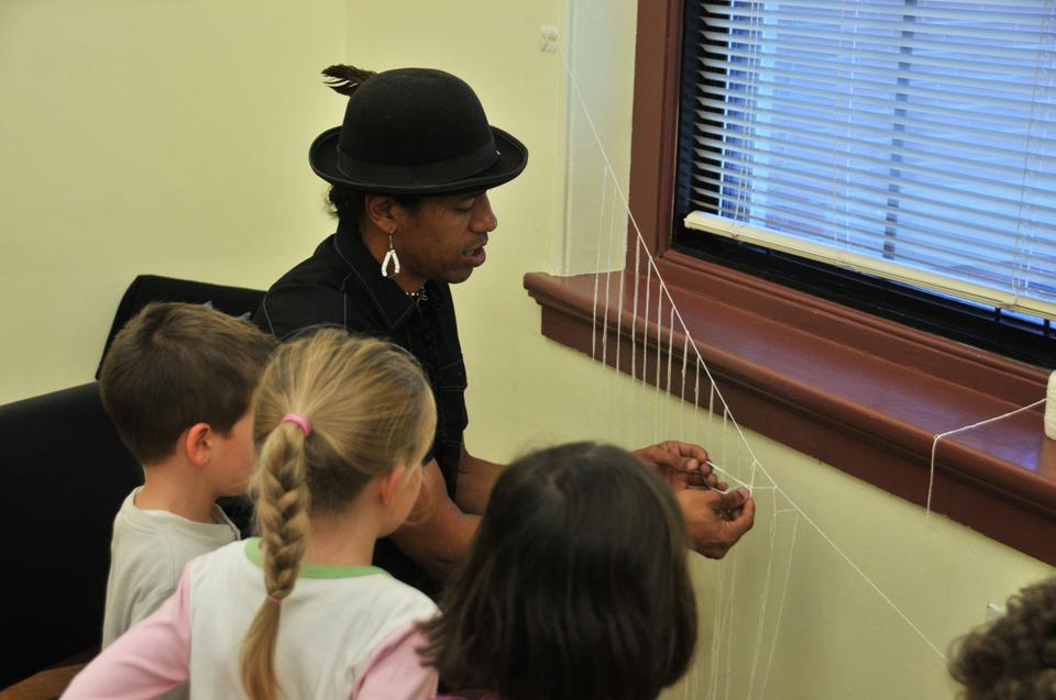 Annawon Weeden, a member of the Mashpee Wampanoag tribe (Massachusetts), teaching the kids how to tie knots, a common practice among the tribe during the Spring season.
