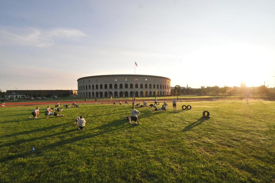 Students from Harvard, MIT, and Tufts broke into pairs for some of their exercises like sit-ups and push-ups during their 6:30AM practice on Monday morning at McCurdy Field in Allston.