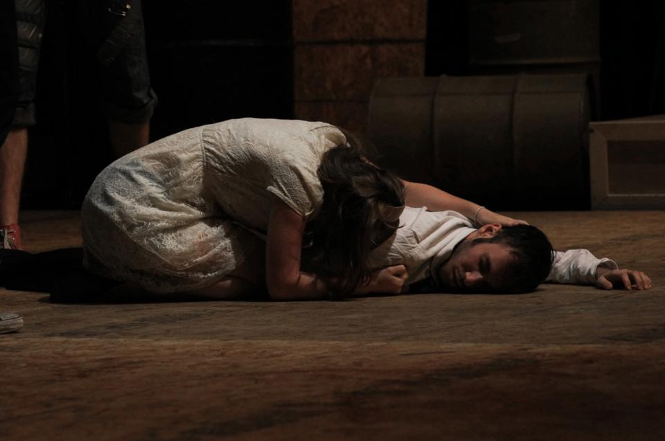 Eli E. Kahn '13 as Bassianus lays dead as his wife Lavinia, played by Alice Abracen '15, expresses grief over his murder.        