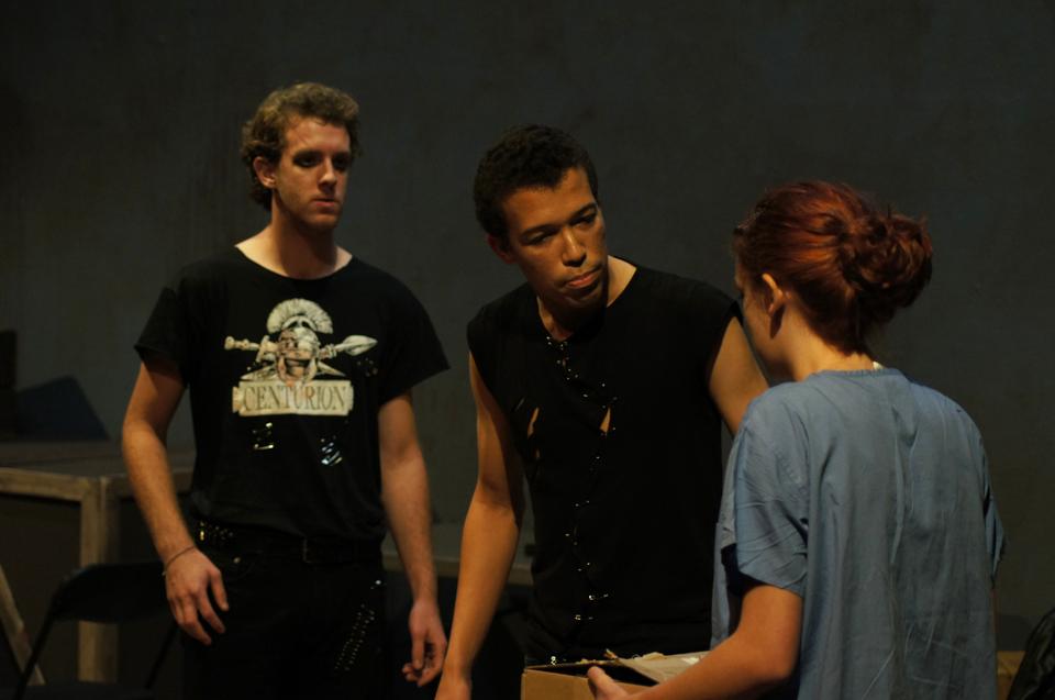 A nurse presents the Moor Aaron, played by Spencer J. Horne '14, with his bastard child, as Demetrius, played by Jesse T. Nee-Vogelman '13, watches on.
