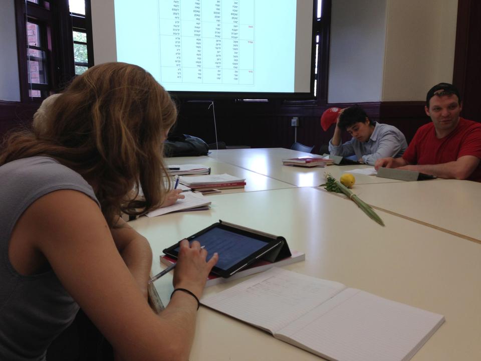 Students in Intermediate Modern Hebrew class learn about verb conjugation using the digital textbook that senior preceptor Irit Aharony has created for the course. Harvard has provided iPads to students for use throughout the semester.