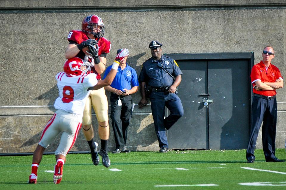 Junior wide receiver Andrew Berg makes a leaping catch over Cornell's Kendall Brown in the Harvard football team's 45-13 victory over the Big Red on Saturday afternoon. Berg's three receiving touchdowns in the contest tied the Crimson's single-game program record.